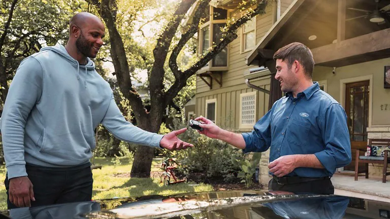 Customer Receiving Key from FORD Technician